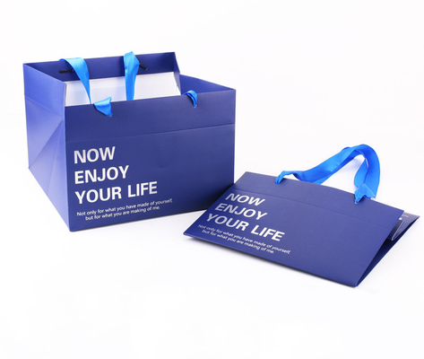 ซื้อ กระเป๋าใส่กระดาษก้นสี่เหลี่ยมขนาดใหญ่พิมพ์แบบกำหนดเองพร้อมที่จับริบบิ้นซาติน online manufacture